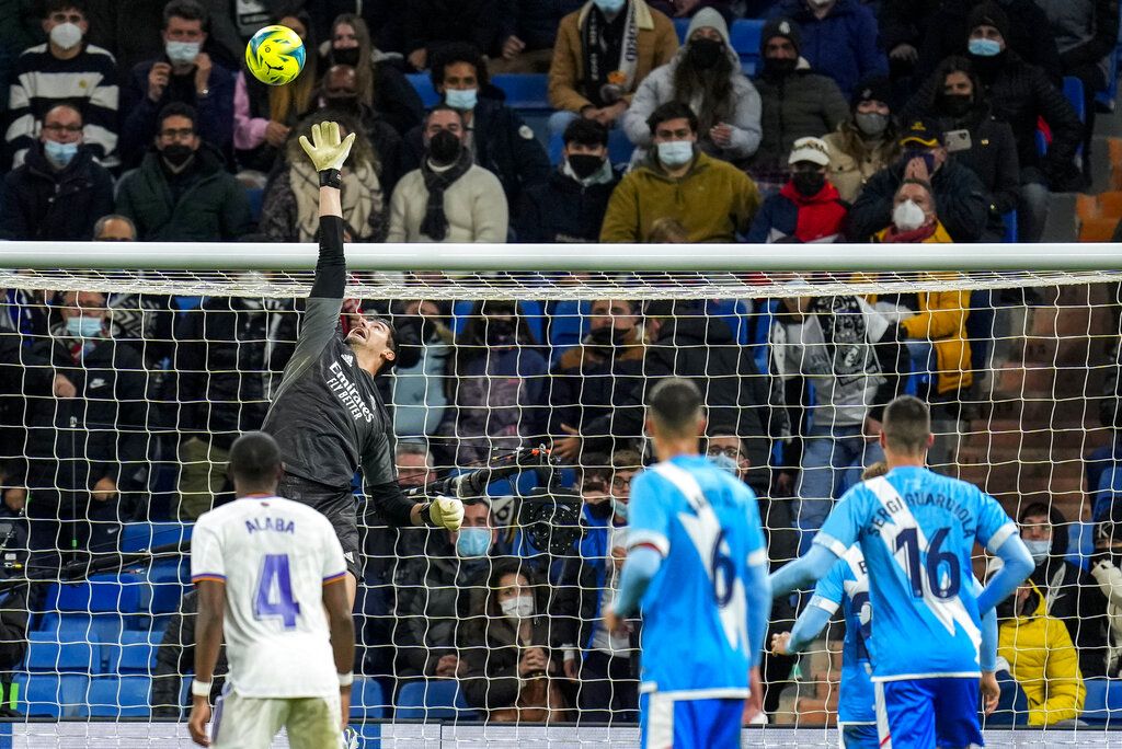 Real Madrid's goalkeeper Thibaut Courtois celebrates after teammate Toni Kroos scored the opening goal during the Champions League group D soccer match between Real Madrid and Inter Milan at the Santiago Bernabeu stadium, in Madrid, Spain, Tuesday, Dec. 7, 2021. (AP Photo/Bernat Armangue)