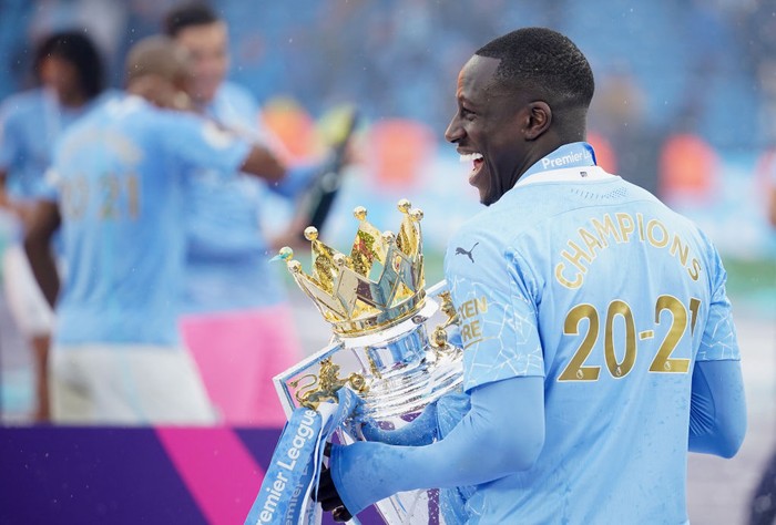 Benjamin Mendy MANCHESTER, ENGLAND - MAY 23: Benjamin Mendy of Manchester City celebrates with the Premier League Trophy as Manchester City are presented with the Trophy as they win the league following the Premier League match between Manchester City and Everton at Etihad Stadium on May 23, 2021 in Manchester, England. A limited number of fans will be allowed into Premier League stadiums as Coronavirus restrictions begin to ease in the UK. (Photo by Dave Thompson - Pool/Getty Images)