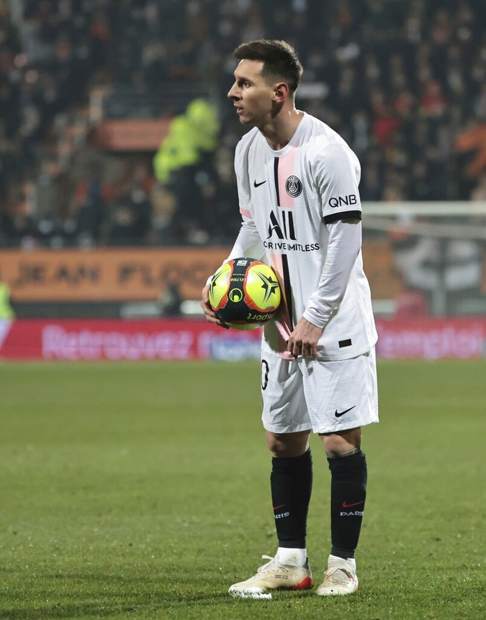 PSG's Lionel Messi holds the ball during the French League One soccer match between FC Lorient and Paris Saint-Germain at the Moustoir stadium in Lorient, western France, Wednesday, Dec. 22, 2021. (AP Photo/Jeremias Gonzalez)