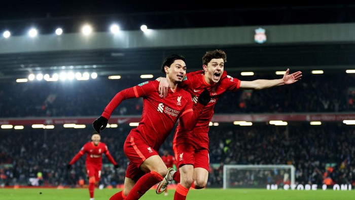 LIVERPOOL, ENGLAND - DECEMBER 22: Takumi Minamino of Liverpool celebrates scoring his teams third goal of the game with team mate Owen Beck during the Carabao Cup Quarter Final match between  Liverpool and Leicester City at Anfield on December 22, 2021 in Liverpool, England. (Photo by Naomi Baker/Getty Images)