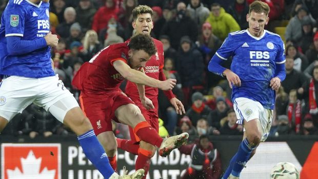 Liverpool's Diogo Jota, center, scores his sides second goal during the English League Cup quarter-final soccer match between Liverpool and Leicester City, at Anfield Stadium, in Liverpool, England, Wednesday Dec. 22, 2021. (AP Photo/Jon Super)