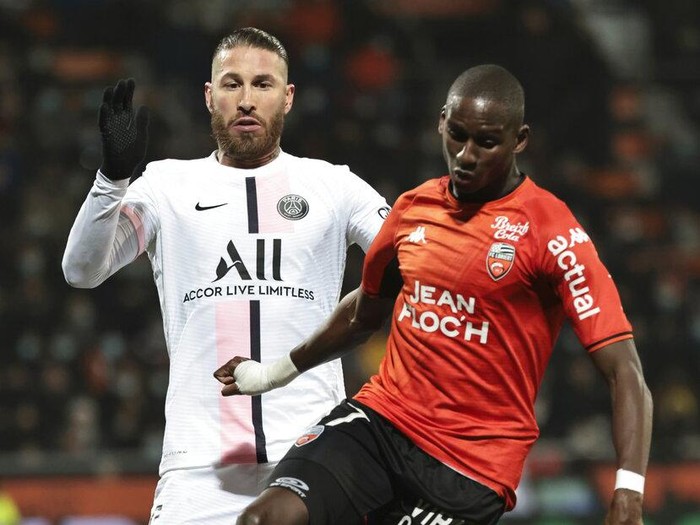Lorient's Houboulang Mendes, right, and PSG's Sergio Ramos challenge for the ball during the French League One soccer match between FC Lorient and Paris Saint-Germain at the Moustoir stadium in Lorient, western France, Wednesday, Dec. 22, 2021. (AP Photo/Jeremias Gonzalez)