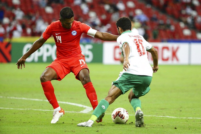 Ricky Richardo Kambuaya of Indonesia, right, attempts to dribble past Hariss Harun of Singapore during the AFF Suzuki Cup 2020 semi-final first leg match between Singapore and Indonesia in Singapore, Wednesday, Dec. 22, 2021. (AP Photo/Suhaimi Abdullah)