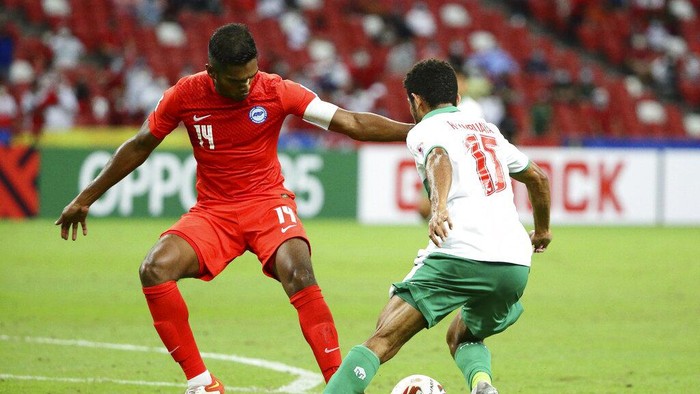 Ricky Richardo Kambuaya of Indonesia, right, attempts to dribble past Hariss Harun of Singapore during the AFF Suzuki Cup 2020 semi-final first leg match between Singapore and Indonesia in Singapore, Wednesday, Dec. 22, 2021. (AP Photo/Suhaimi Abdullah)