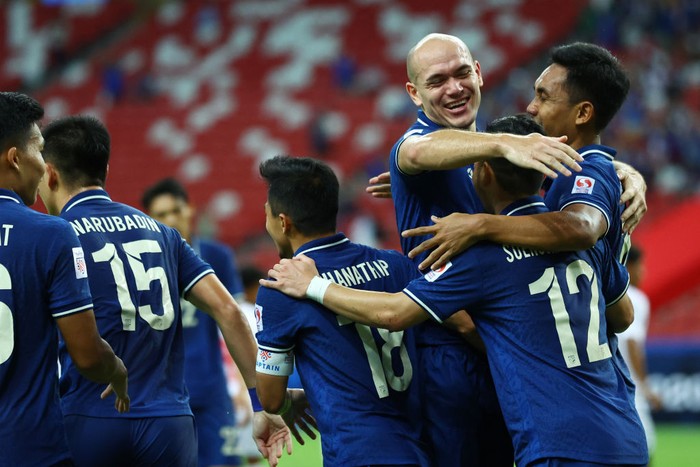 SINGAPORE, SINGAPORE - DECEMBER 11: Teerasil Dangda #10 (R) of Thailand celebrates with his teammates after scoring their first goal against Myanmar during the first half of their AFF Suzuki Cup Group A game at the National Stadium on December 11, 2021 in Singapore. (Photo by Yong Teck Lim/Getty Images)