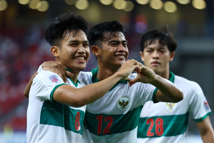 SINGAPORE, SINGAPORE - DECEMBER 22: Witan Sulaeman #8 of Indonesia celebrates with Pratama Arhan Alif Rifai #12 after scoring their first goal against Singapore during the first half of the first leg of their AFF Suzuki Cup semifinal at the National Stadium on December 22, 2021 in Singapore. (Photo by Yong Teck Lim/Getty Images)