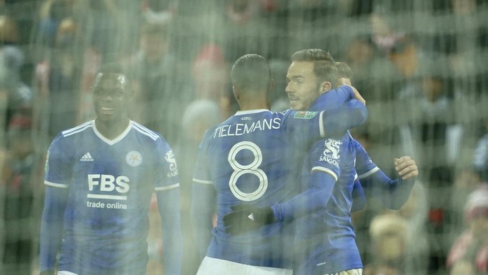 Leicesters James Maddison, right, celebrates with teammates after scoring his sides third goal during the English League Cup quarter-final soccer match between Liverpool and Leicester City, at Anfield Stadium, in Liverpool, England, Wednesday Dec. 22, 2021. (AP Photo/Jon Super)