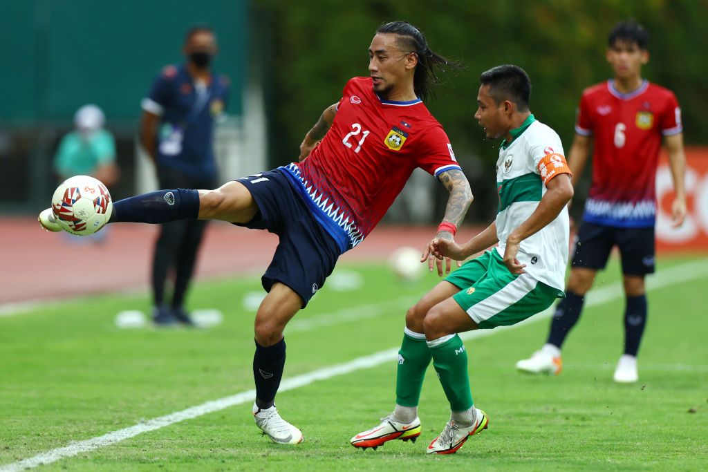 SINGAPORE, SINGAPORE - DECEMBER 12: Evan Dimas Darmono #6 of Indonesia celebrates after scoring his team's fifth goal as Loungleuang Keophouvong #25 of Laos reacts during the second half of their AFF Suzuki Cup Group B game at Bishan Stadium on December 12, 2021 in Singapore. (Photo by Yong Teck Lim/Getty Images)
