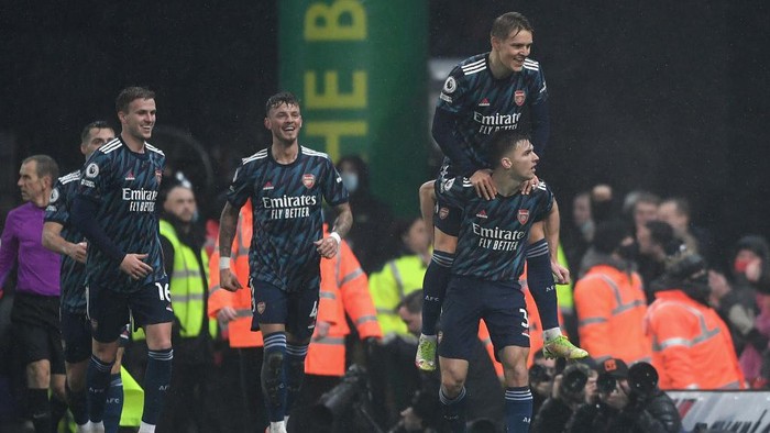 NORWICH, ENGLAND - DECEMBER 26: Kieran Tierney celebrates with teammate Martin Odegaard of Arsenal after scoring their teams second goal during the Premier League match between Norwich City and Arsenal at Carrow Road on December 26, 2021 in Norwich, England. (Photo by Harriet Lander/Getty Images)