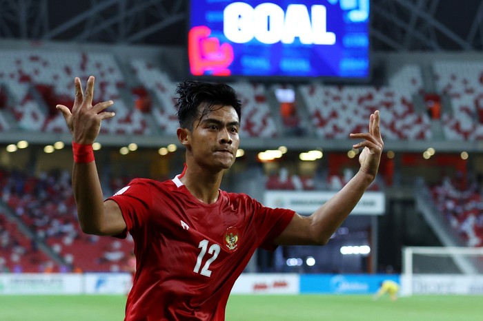 SINGAPORE, SINGAPORE - DECEMBER 25: Pratama Arhan Alif Rifai #12 of Indonesia celebrates after scoring his teams second goal against Singapore during the second half of the second leg of their AFF Suzuki Cup semifinal at the National Stadium on December 25, 2021 in Singapore. (Photo by Yong Teck Lim/Getty Images)
