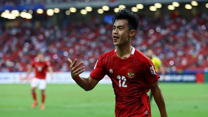 SINGAPORE, SINGAPORE - DECEMBER 25: Pratama Arhan Alif Rifai #12 of Indonesia celebrates after scoring his teams second goal against Singapore during the second half of the second leg of their AFF Suzuki Cup semifinal at the National Stadium on December 25, 2021 in Singapore. (Photo by Yong Teck Lim/Getty Images)