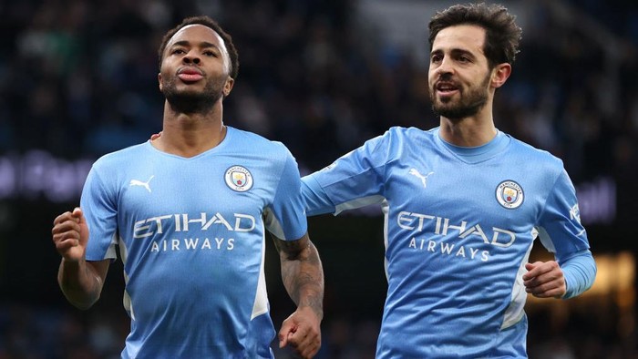 MANCHESTER, ENGLAND - DECEMBER 26: Raheem Sterling of Manchester City celebrates after scoring their sides fourth goal with Bernardo Silva during the Premier League match between Manchester City and Leicester City at Etihad Stadium on December 26, 2021 in Manchester, England. (Photo by Alex Pantling/Getty Images)