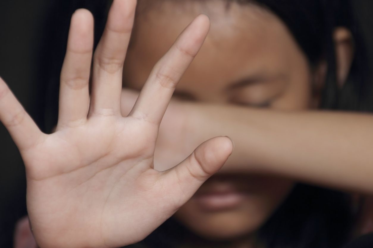 Little girl suffering bullying raises her palm asking to stop the violence