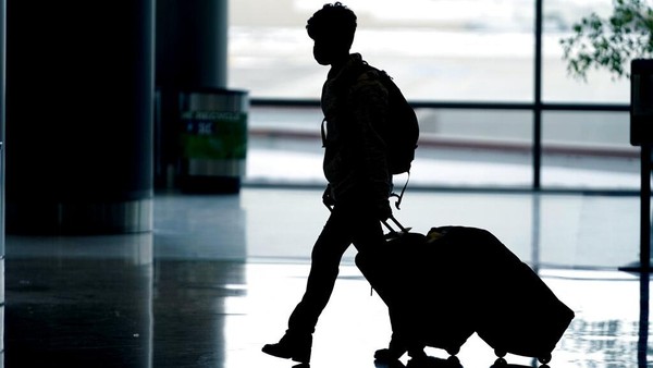 Wisatawan melewati Bandara Internasional Salt Lake City Senin, 27 Desember 2021, di Salt Lake City. (Foto AP/Rick Bowmer)