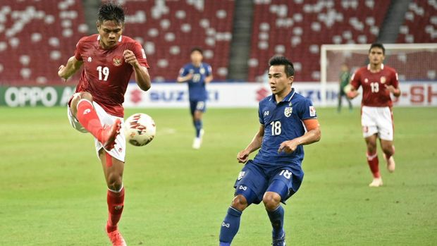 Pesepak bola Timnas Indonesia Fachruddin Aryanto (kiri) berebut bola dengan pesepak bola Timnas Thailand Chanatip Songkrasin (kanan) dalam pertandingan Babak Final Leg 1 Piala AFF 2020 di National Stadium, Singapura, Rabu (29/12/2021).  ANTARA FOTO/Flona Hakim/app/aww.