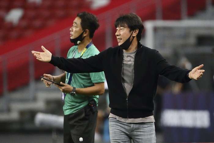 Indonesia head coach, Shin Tae Yong reacts at the touchline during the AFF Suzuki Cup 2020 semi-final second leg match between Indonesia and Singapore in Singapore, Sunday, Dec. 26, 2021. (AP Photo/Suhaimi Abdullah)