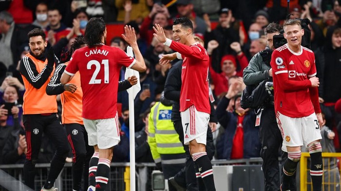 MANCHESTER, ENGLAND - DECEMBER 30: Cristiano Ronaldo of Manchester United celebrates with team mate Edinson Cavani after scoring their sides third goal during the Premier League match between Manchester United and Burnley at Old Trafford on December 30, 2021 in Manchester, England. (Photo by Dan Mullan/Getty Images)