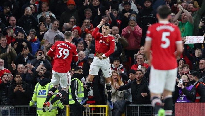 MANCHESTER, ENGLAND - DECEMBER 30: Cristiano Ronaldo of Manchester United celebrates after scoring their sides third goal during the Premier League match between Manchester United and Burnley at Old Trafford on December 30, 2021 in Manchester, England. (Photo by Clive Brunskill/Getty Images)