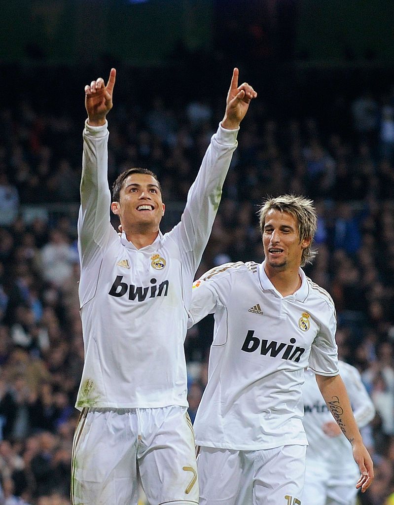MADRID, SPAIN - FEBRUARY 09:  Cristiano Ronaldo (R) of Real Madrid celebrates scoring his sides second goal with his teammate Fabio Coentrao of Real Madrid during the la Liga match between Real Madrid CF and Sevilla FC at Estadio Santiago Bernabeu on February 9, 2013 in Madrid, Spain.  (Photo by Jasper Juinen/Getty Images)