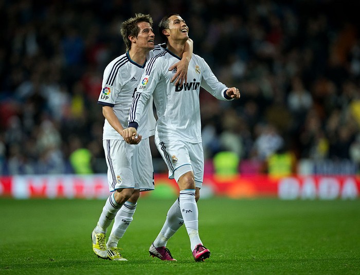 MADRID, SPAIN - FEBRUARY 09:  Cristiano Ronaldo (R) of Real Madrid celebrates scoring his sides second goal with his teammate Fabio Coentrao of Real Madrid during the la Liga match between Real Madrid CF and Sevilla FC at Estadio Santiago Bernabeu on February 9, 2013 in Madrid, Spain.  (Photo by Jasper Juinen/Getty Images)
