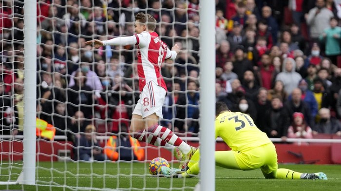 Manchester Citys goalkeeper Ederson, right, challenges Arsenals Martin Odegaard during the Premier League soccer match between Arsenal and Manchester City at the Emirates Stadium, in London, England, Saturday Jan. 1, 2022. (AP Photo/Matt Dunham)