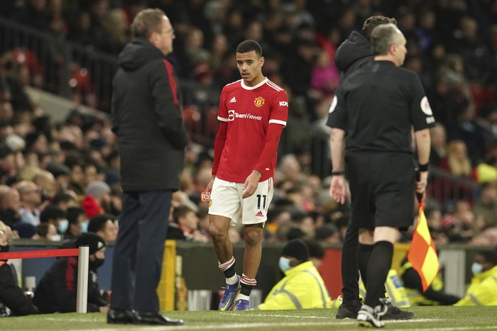Manchester Uniteds Mason Greenwood looks at Manchester Uniteds manager Ole Gunnar Solskjaer, left, after being substituted during the English Premier League soccer match between Manchester United and Wolverhampton Wanderers at Old Trafford stadium in Manchester, England, Monday, Jan.3, 2022. (AP Photo/Dave Thompson)