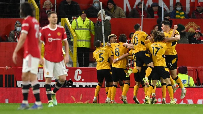 MANCHESTER, ENGLAND - JANUARY 03: Joao Moutinho of Wolverhampton Wanderers celebrates with teammates  after scoring their sides first goal during the Premier League match between Manchester United and Wolverhampton Wanderers at Old Trafford on January 03, 2022 in Manchester, England. (Photo by Gareth Copley/Getty Images)
