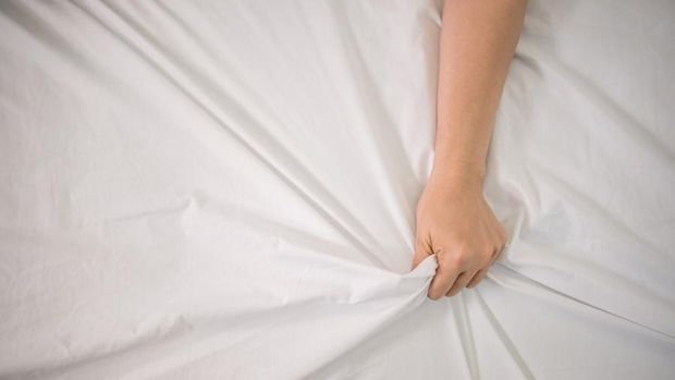 Romantic Happy couple in bed enjoying sensual foreplay.