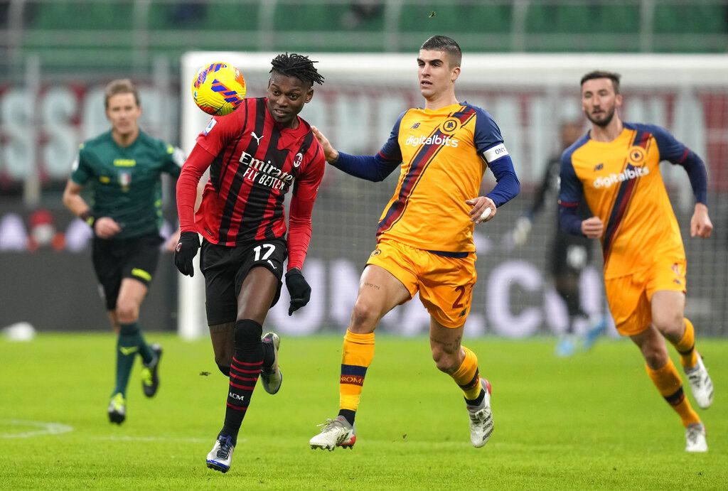 AC Milan's Rafael Leao challenges for the ball with Roma's Gianluca Mancini during the Serie A soccer match between AC Milan and Roma at the San Siro stadium, in Milan, Italy, Thursday, Jan. 6, 2022. (AP Photo/Antonio Calanni)