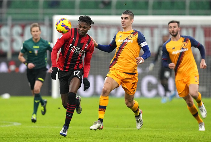 AC Milans Rafael Leao challenges for the ball with Romas Gianluca Mancini during the Serie A soccer match between AC Milan and Roma at the San Siro stadium, in Milan, Italy, Thursday, Jan. 6, 2022. (AP Photo/Antonio Calanni)