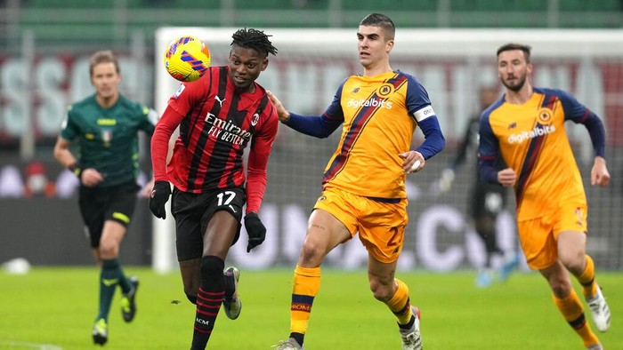 AC Milans Rafael Leao challenges for the ball with Romas Gianluca Mancini during the Serie A soccer match between AC Milan and Roma at the San Siro stadium, in Milan, Italy, Thursday, Jan. 6, 2022. (AP Photo/Antonio Calanni)