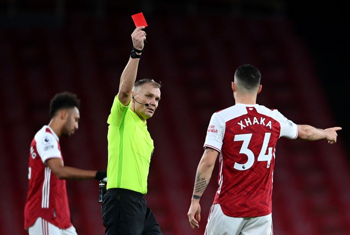 LONDON, ENGLAND - DECEMBER 13: Granit Xhaka of Arsenal is shown a red card by match referee Graham Scott during the Premier League match between Arsenal and Burnley at Emirates Stadium on December 13, 2020 in London, England. A limited number of spectators (2000) are welcomed back to stadiums to watch elite football across England. This was following easing of restrictions on spectators in tiers one and two areas only. (Photo by Laurence Griffiths/Getty Images)