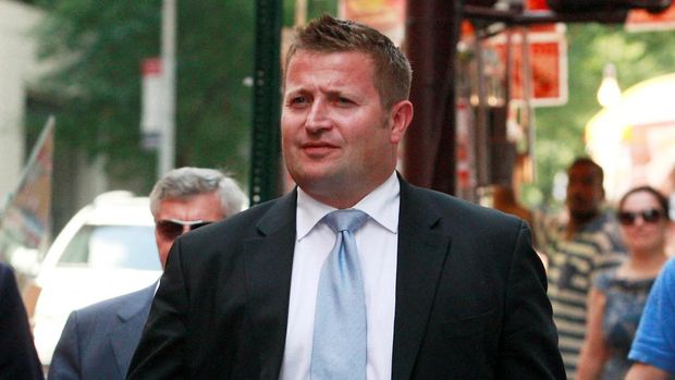 FILE PHOTO: Richard Arnold, commercial director of Manchester United, walks with members of the Manchester United Ltd. IPO road show marketing team following their meetings with bankers in New York, August 6, 2012. Manchester United Ltd's owners stand to make about three times their investment in the British soccer club if it successfully goes public. REUTERS/Brendan McDermid (UNITED STATES  - Tags: BUSINESS SPORT SOCCER)/File Photo