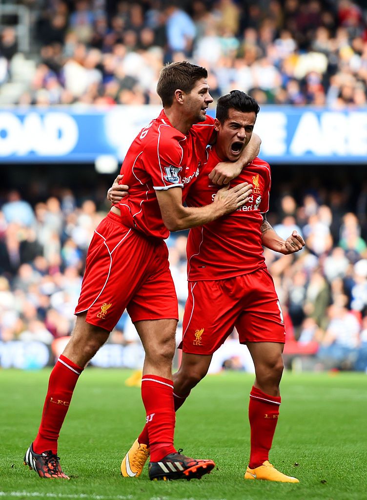 LONDON, ENGLAND - OCTOBER 19:  Philippe Coutinho of Liverpool celebrates with team-mate Steven Gerrard after scoring his team's second goal during the Barclays Premier League match between Queens Park Rangers and Liverpool at Loftus Road on October 19, 2014 in London, England.  (Photo by Paul Gilham/Getty Images)