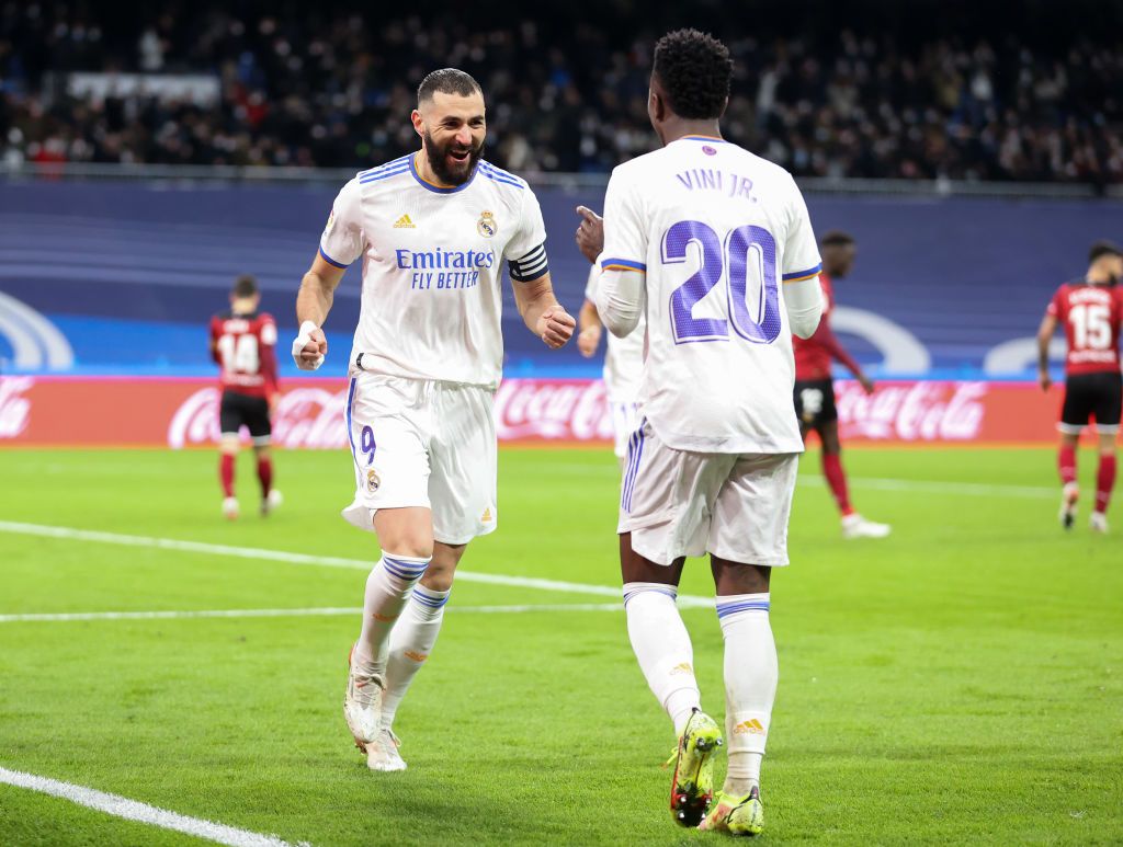 MADRID, SPAIN - JANUARY 08: Vinicius Jr of Real Madrid CF celebrates with his team mate Karim Benzema after scoring his team's second goal during the La Liga Santader match between Real Madrid CF and Valencia CF at Estadio Santiago Bernabeu on January 8, 2022 in Madrid, Spain. (Photo by Gonzalo Arroyo Moreno/Getty Images)