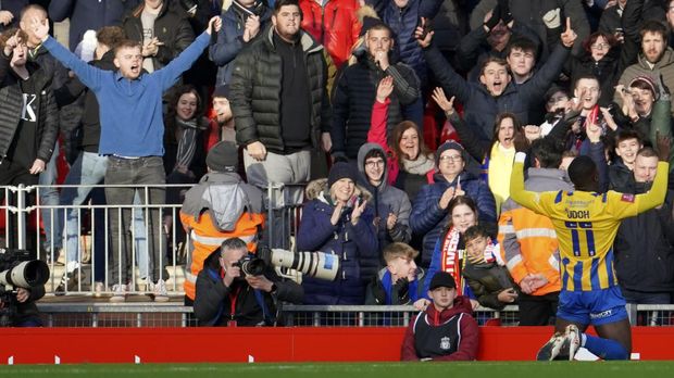 Shrewsbury's Daniel Udoh celebrates after scoring his side's opening goal during the English FA Cup third round soccer match between Liverpool and Shrewsbury Town at Anfield stadium in Liverpool, Sunday, Jan. 9, 2022. (AP Photo/Jon Super)