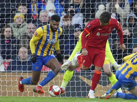 Liverpool's Roberto Firmino, center, scores his side's third goal during the English FA Cup third round soccer match between Liverpool and Shrewsbury Town at Anfield stadium in Liverpool, Sunday, Jan. 9, 2022. (AP Photo/Jon Super)