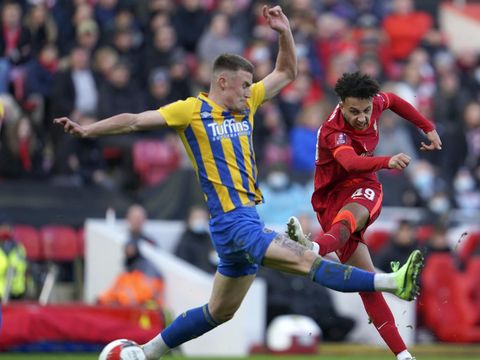 Liverpool's Kaide Gordon, right, kicks the ball during the English FA Cup third round soccer match between Liverpool and Shrewsbury Town at Anfield stadium in Liverpool, Sunday, Jan. 9, 2022. (AP Photo/Jon Super)