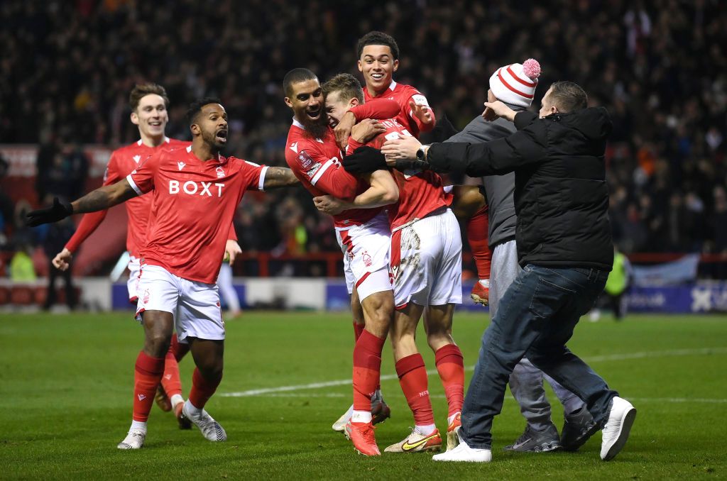 NOTTINGHAM, ENGLAND - JANUARY 09: Lewis Grabban of Nottingham Forest celebrates with teammates and fans after scoring their side's first goal during the Emirates FA Cup Third Round match between Nottingham Forest and Arsenal at City Ground on January 09, 2022 in Nottingham, England. (Photo by Laurence Griffiths/Getty Images)