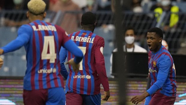 Barcelona's players celebrate a goal during the Spanish Super Cup semi final soccer match between Barcelona and Real Madrid at King Fahd stadium in Riyadh, Saudi Arabia, Wednesday, Jan. 12, 2022. (AP Photo/Hassan Ammar)