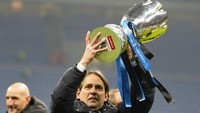 Pelatih kepala Inter Milan Simone Inzaghi memegang trofi setelah memenangkan pertandingan sepak bola final Piala Super Italia antara Inter Milan dan Juventus. Inter Milan menang 2-1. (AP/Luca Bruno)