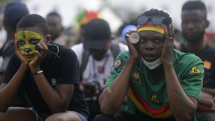 Cameroon supporters react at the fan zone in Doula, following a goal scored by Gustavo Sangaré, of Burkina Faso, during the African Cup of Nations 2022 group A soccer match between Cameroon and Burkina Faso at the Olembe stadium in Yaounde, Cameroon, Sunday, Jan. 9, 2022. (AP Photo/Sunday Alamba)