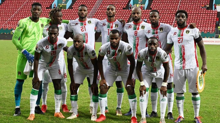 (FromL) Back row: Mauritanias players, goalkeeper Babacar Diop, forward Pape Ibnou Ba, defender El Hassen Houebib, midfielder Abdallahi Mahmoud, midfielder Guessouma Fofana, midfielder Mohamed Yali Dellahi forward Aboubakar Kamara; (front row): defender Abdoulkader Thiam, midfielder Almike Moussa NDiaye, defender Aly Abeid and defender Souleymane Karamoko pose before the Group F Africa Cup of Nations (CAN) 2021 football match between Mauritania and Gambia at Limbe Omnisport Stadium in Limbe on January 12, 2022. (Photo by Issouf SANOGO / AFP)