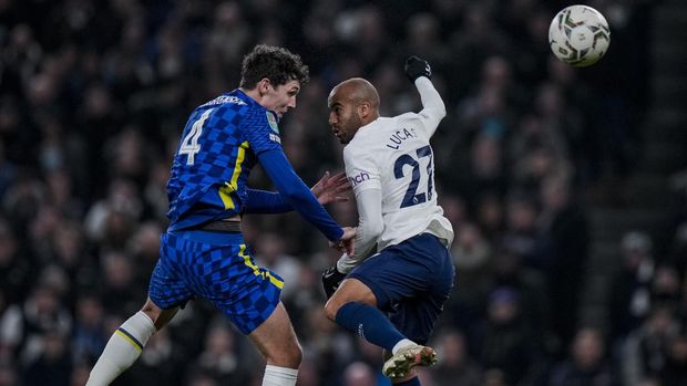 Tottenham's Lucas Moura, right, and Chelsea's Andreas Chistensen jump for the ball during the English League Cup semifinal second leg soccer match between Tottenham Hotspur and Chelsea at the Tottenham Hotspur Stadium in London, Wednesday, Jan. 12, 2022. (AP Photo/Alastair Grant)