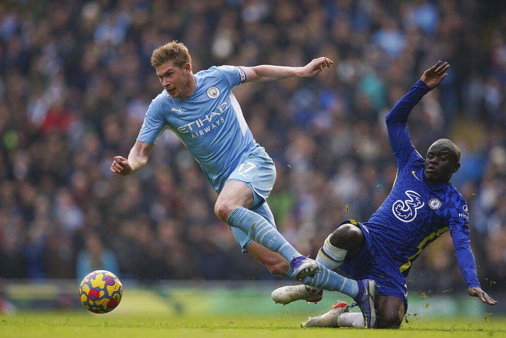 Manchester City's Kevin De Bruyne, left, gets past Chelsea's N'Golo Kante on his way to scoring the opening goal during an English Premier League soccer match between Manchester City and Chelsea at the Etihad stadium in Manchester, England, Saturday, Jan. 15, 2022. (AP Photo/Dave Thompson)