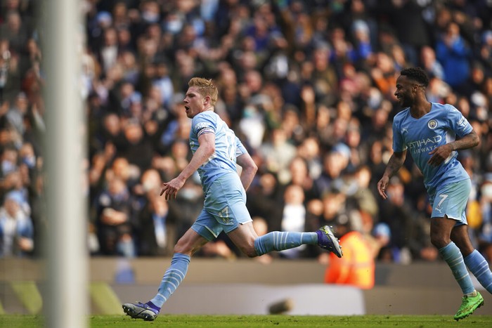 Manchester Citys Kevin De Bruyne, left, reacts after celebrates after scoring the opening goal during an English Premier League soccer match between Manchester City and Chelsea at the Etihad stadium in Manchester, England, Saturday, Jan. 15, 2022. (AP Photo/Dave Thompson)