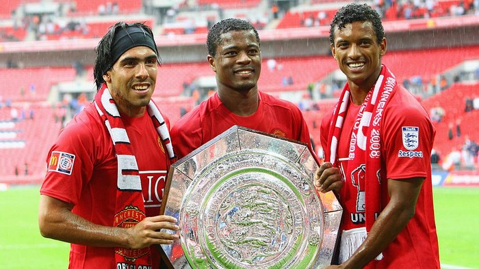 LONDON - AUGUST 10:  (R-L) Luis Nani, Patrice Evra and Carlos Tevez of Manchester United celebrate with the trophy as they are victorious on penalty kicks during the FA Community Shield match between Manchester United and Portsmouth at Wembley Stadium on August 10, 2008 in London, England.  (Photo by Phil Cole/Getty Images)