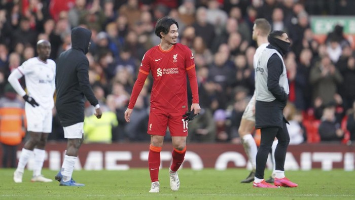 Liverpools 3rd goal scorer Takumi Minamino smiles at he end of an English Premier League soccer match between Liverpool and Brentford at Anfield in Liverpool, England, Sunday, Jan. 16, 2022. (AP Photo/Jon Super)