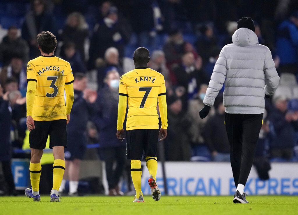Chelsea's Marcos Alonso, left, Chelsea's N'Golo Kante, center, and Chelsea's head coach Thomas Tuchel leave the field after the English Premier League soccer match between Brighton and Chelsea at the Falmer stadium in Brighton, England, Tuesday, Jan. 18, 2022. (AP Photo/Matt Dunham)