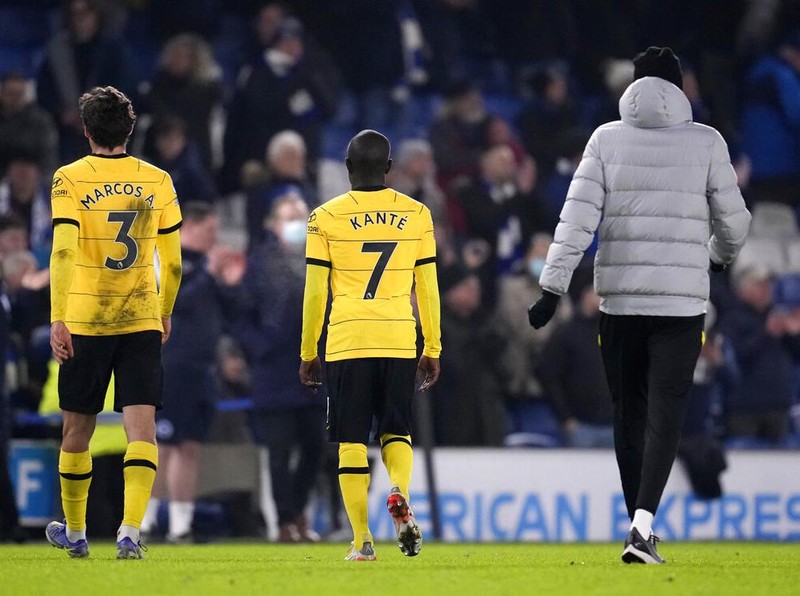 Chelsea's Marcos Alonso, left, Chelsea's N'Golo Kante, center, and Chelsea's head coach Thomas Tuchel leave the field after the English Premier League soccer match between Brighton and Chelsea at the Falmer stadium in Brighton, England, Tuesday, Jan. 18, 2022. (AP Photo/Matt Dunham)